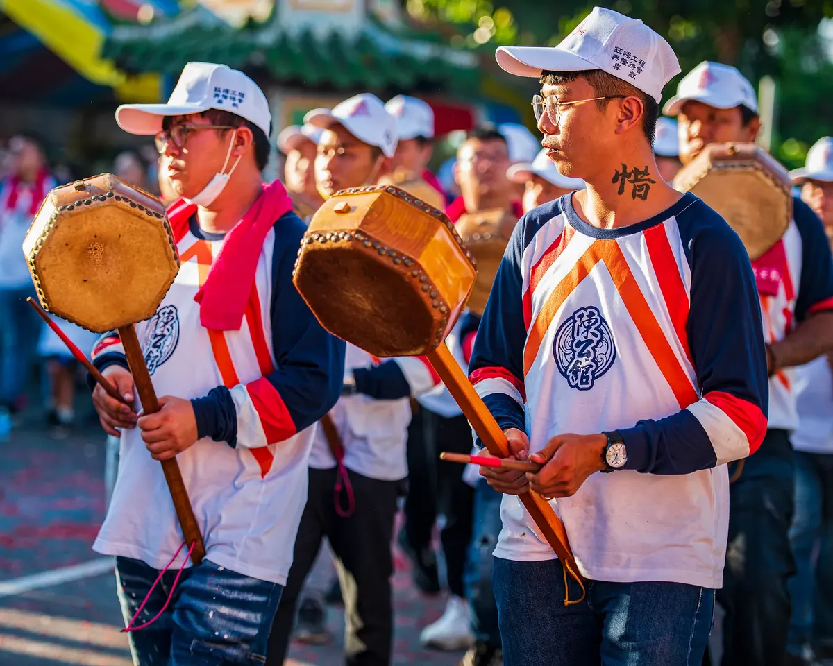 A colorful parade of drummers in Taiwan celebrating cultural heritage with traditional instruments.
