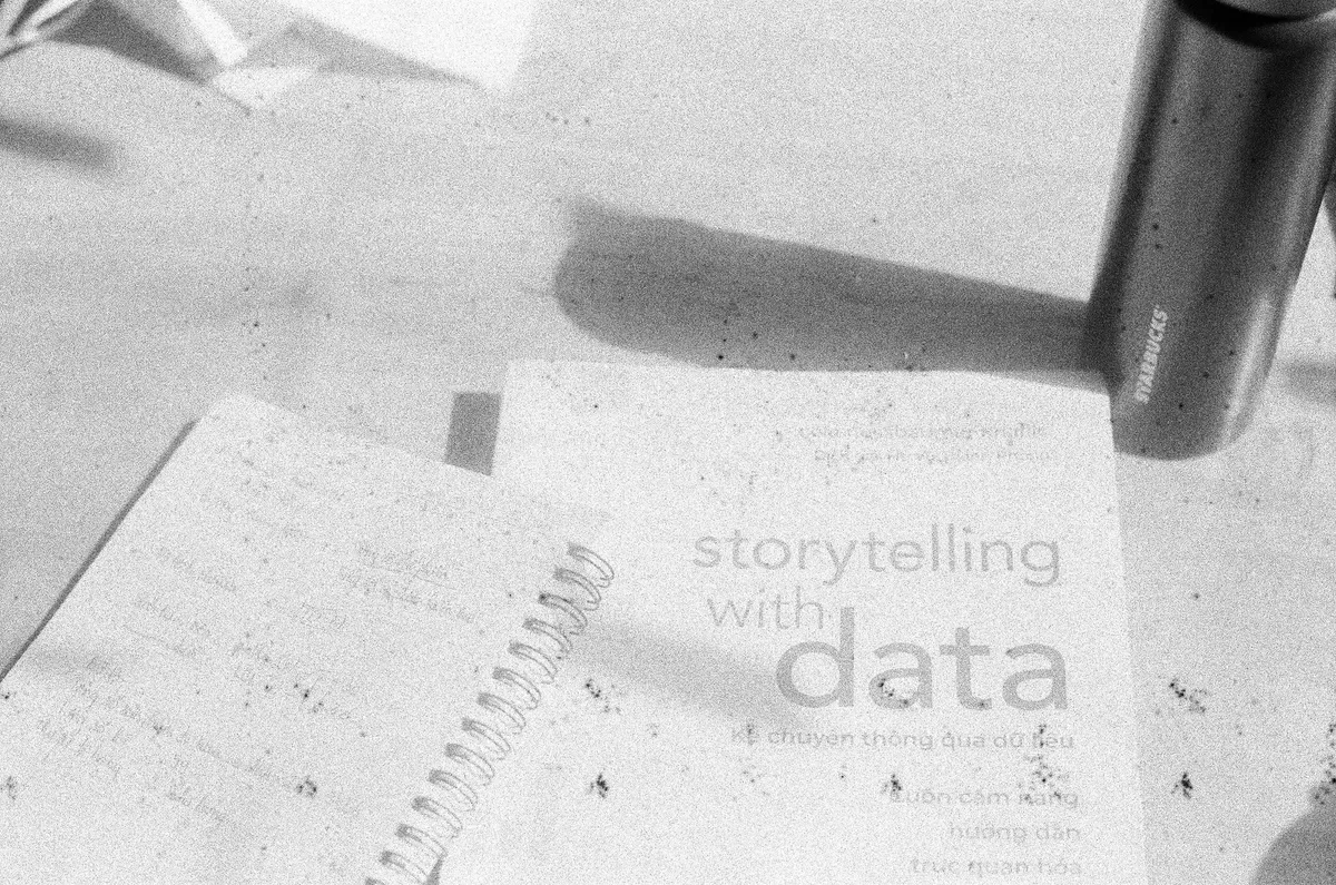 Artistic black and white shot of a notebook and thermos with a focus on storytelling in data.