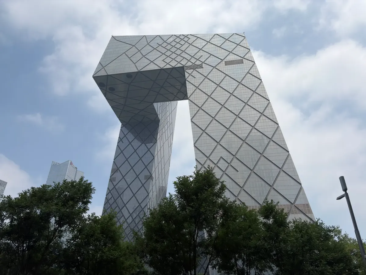 Iconic CCTV Headquarters in Beijing showcasing modern architecture against a blue sky.